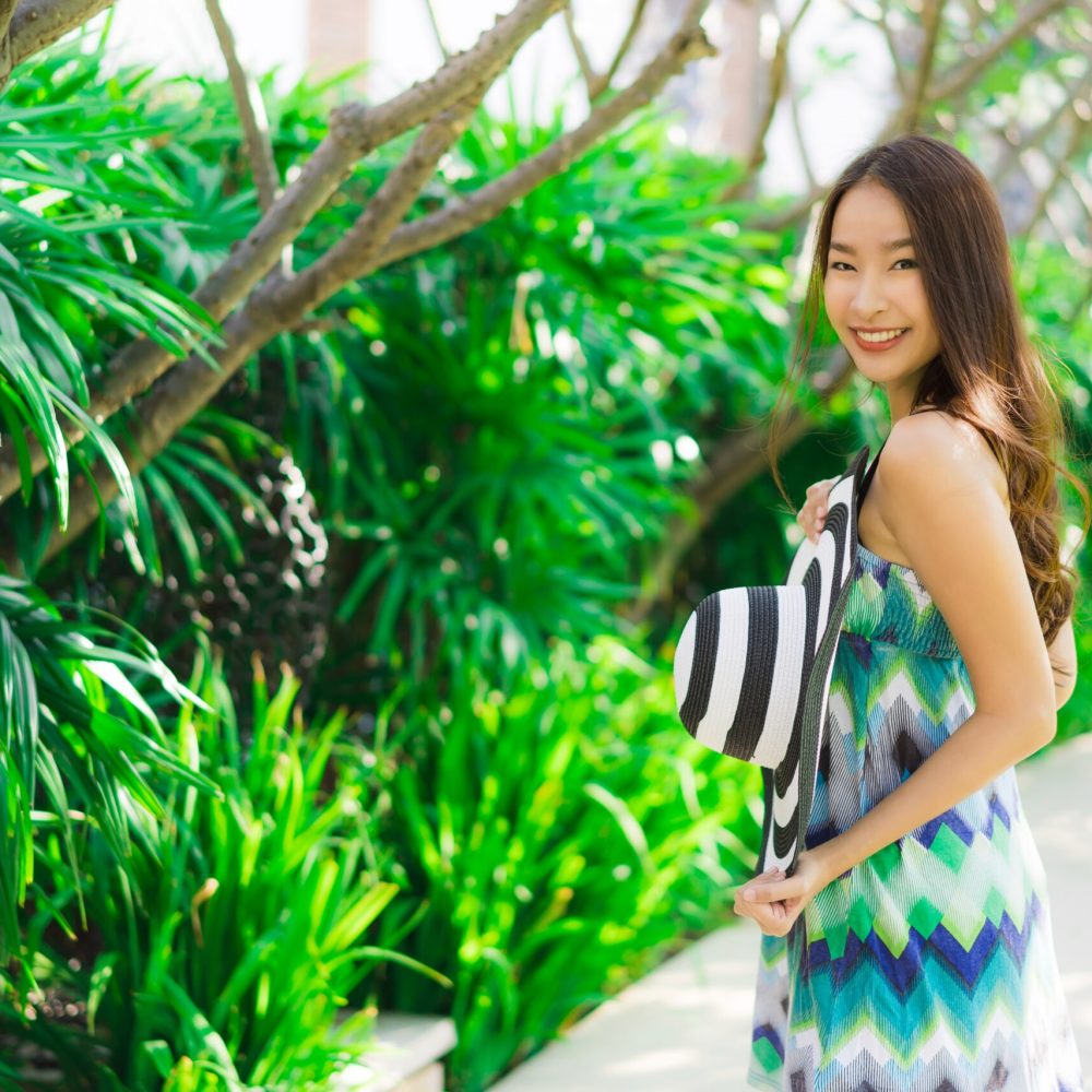 Portrait beautiful young asian woman smile and happy around outdoor garden